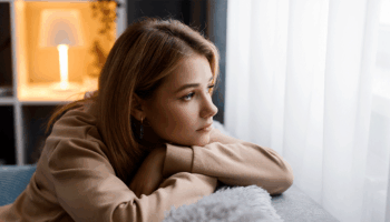 A woman thinking about telling her family she's pregnant before the holidays