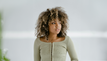Thoughtful woman taking time to consider her pregnancy decision despite pressure from friends and family.